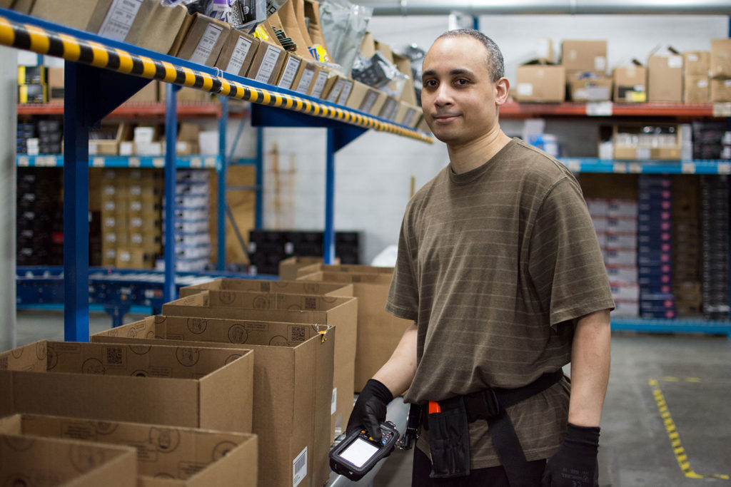 Worker managing inventory at Crutchfield